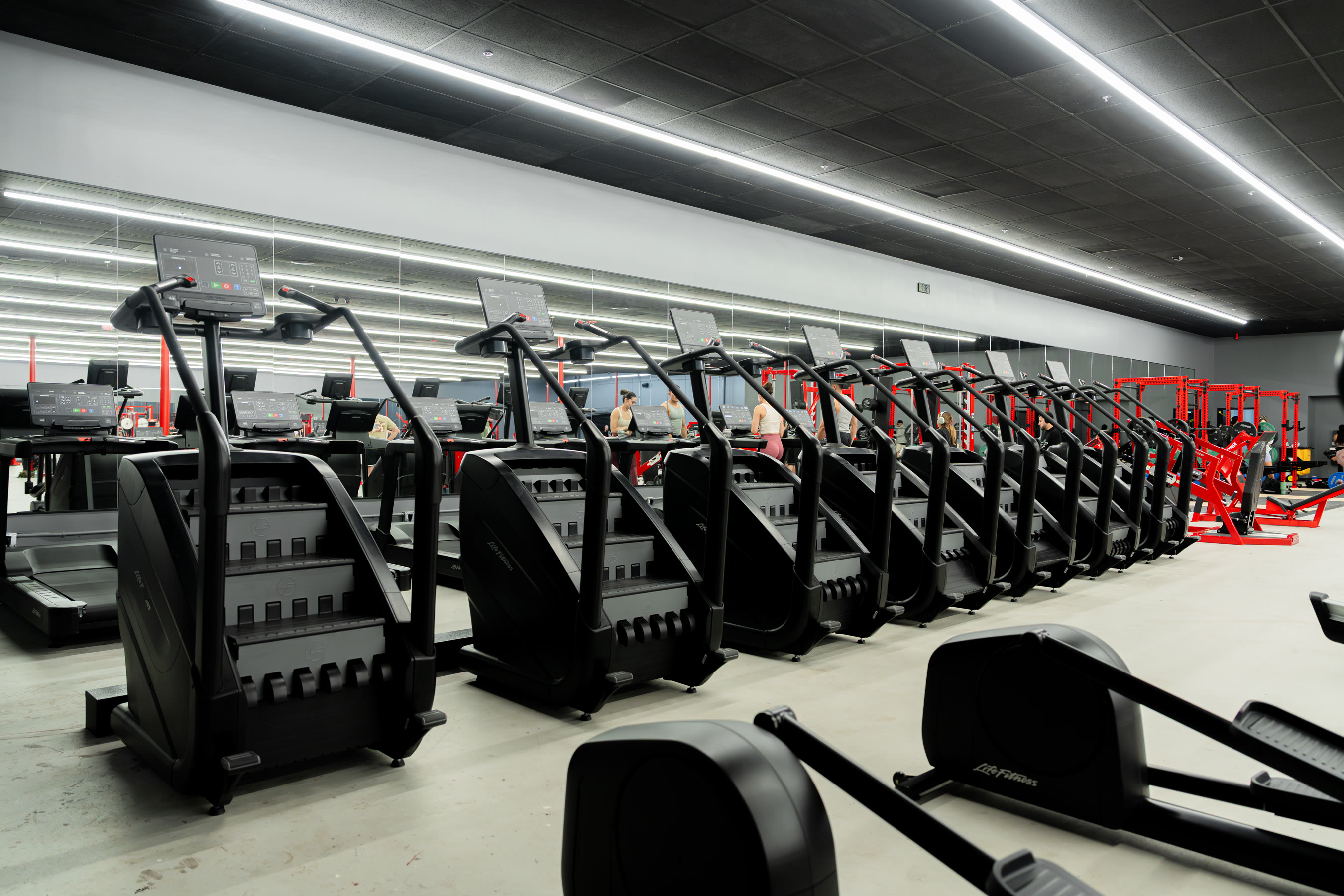Row of StairMaster steppers beneath the black ceiling at Camarillo