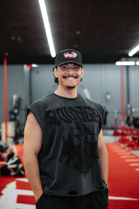 Frank, of the House of Gains Camarillo crew, in a HOGG cap on the red turf